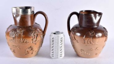 TWO 19TH CENTURY ENGLISH STONEWARE JUGS one with probably silver mounts. Largest 24 cm x 15 cm. (2)