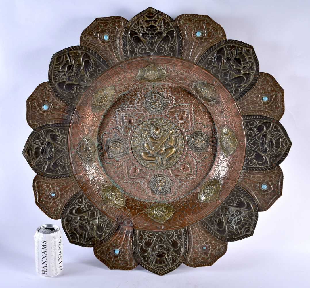 A VERY LARGE 19TH CENTURY INDIAN TIBETAN COPPER AND MIXED METAL CHARGER of monumental proportions,