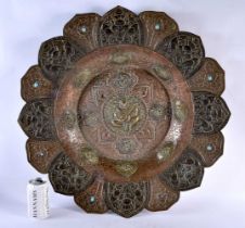 A VERY LARGE 19TH CENTURY INDIAN TIBETAN COPPER AND MIXED METAL CHARGER of monumental proportions,
