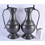 A LARGE PAIR OF ANTIQUE FRENCH PEWTER FLAGONS. 37 cm high.