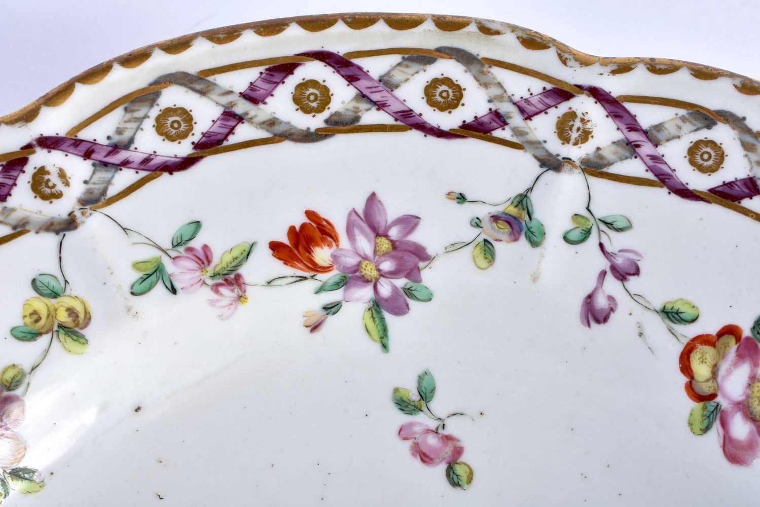 18th century Bristol plate with entwined ribbon border painted with a central flower, chains of - Image 3 of 3