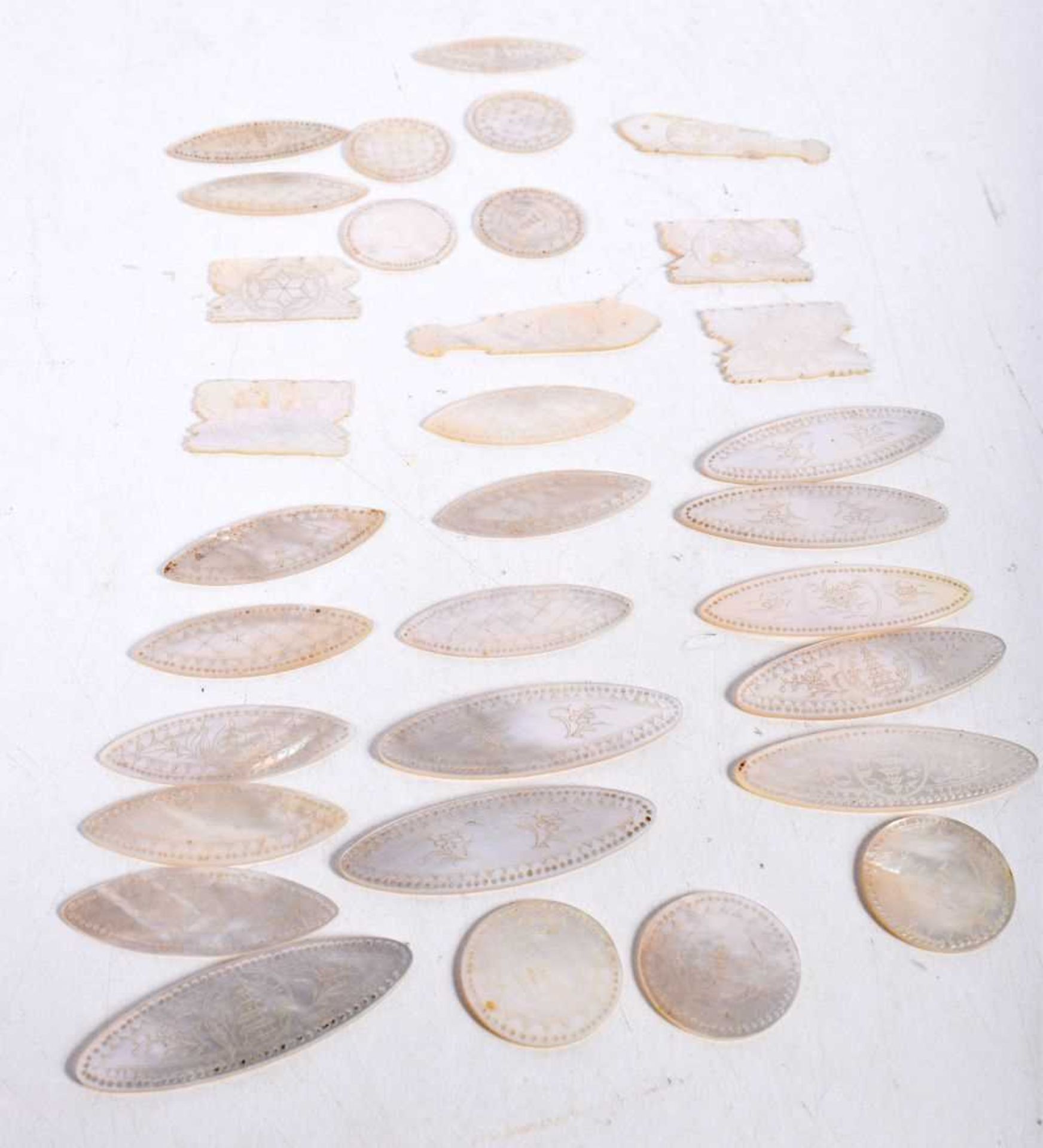 CHINESE MOTHER OF PEARL GAMING COUNTERS. 49.5 grams. Largest 5.25 cm x 1.75 cm. (qty)