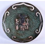 A VINTAGE PERUVIAN SILVER OVERLAID 60627 PLATE depicting a tribal figures. 24 cm diameter.