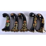 A SET OF FIVE MIDDLE EASTERN QAJAR LACQUER HARDSTONE DAGGER HANDLES overlaid with foliage and vines.