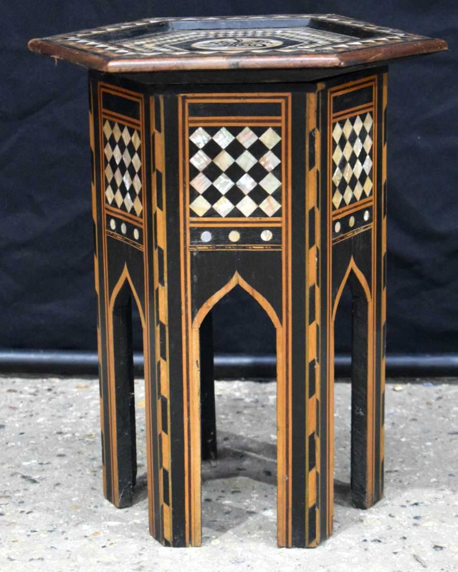 An Islamic wooden hexagonal sided table with Mother of Pearl and wooden inlay 51 x 43cm.