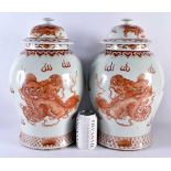 A LARGE PAIR OF CHINESE QING DYNASTY IRON RED PAINTED GINGER JARS AND COVERS painted with Buddhistic