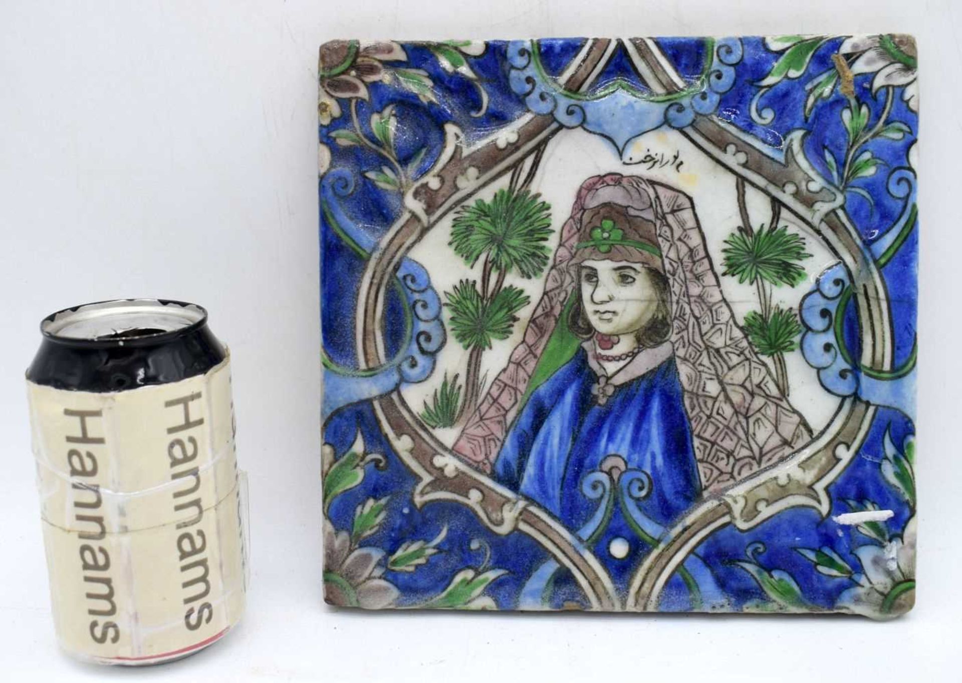 A Qajar glazed pottery tile 20 x 21.5 cm.