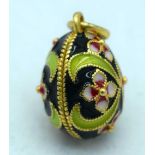 A Continental Silver Gilt and Enamel Egg Pendant. Stamped 84, 2.1cm x 1.5cm, weight 6.7g