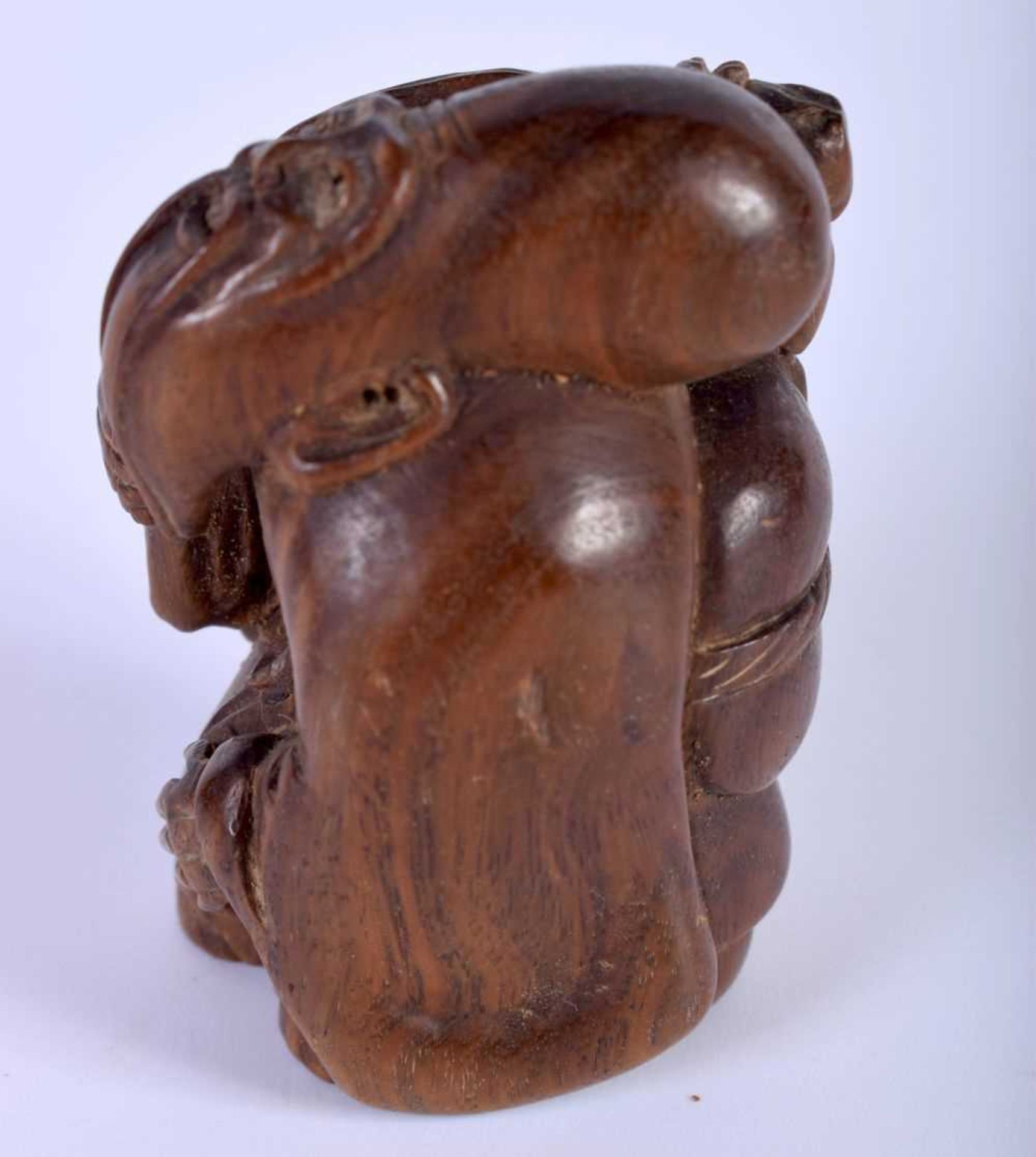 A Carved Hardwood Netsuke of a Male. 5.4cm x 3.2cm x 3.8cm. Weight 47g - Image 2 of 3