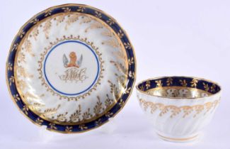 AN OVERSIZED 18TH CENTURY WORCESTER FLUTED ARMORIAL TEABOWL AND SAUCER painted with a central