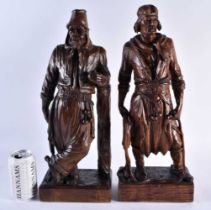 A LARGE PAIR OF EARLY 20TH CENTURY CONTINENTAL CARVED WOOD FIGURES. 44 cm high.