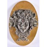 A 19TH CENTURY FRENCH GRAND TOUR SILVERED BRONZE WALL PLAQUE depicting a Romanesque mask head. 18 cm