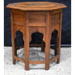 A Persian Nishapur metal inlaid wooden octagonal table 52 x 54 cm