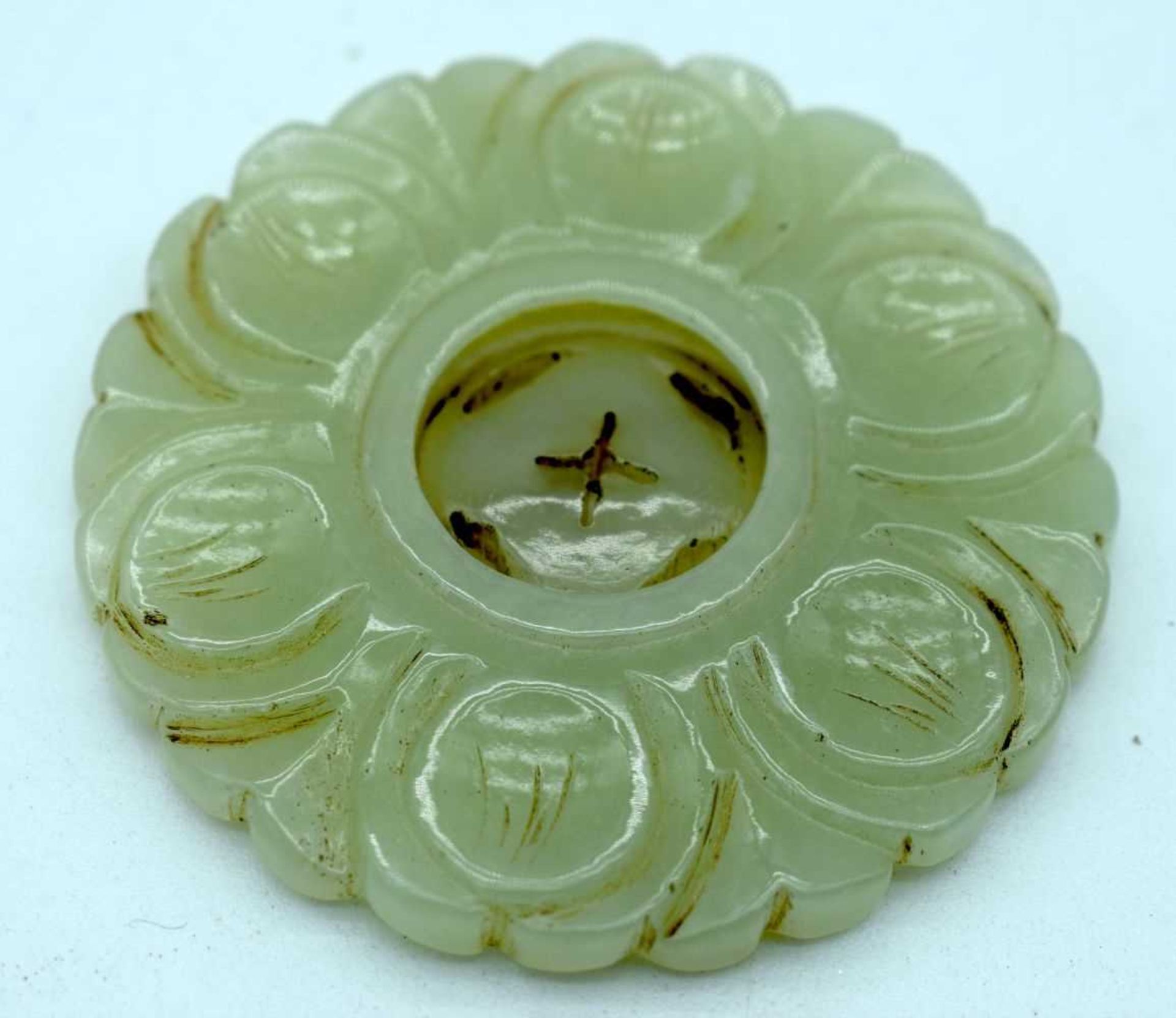 A Carved Jade Roundel. 5cm Diameter. Weight 23.1g