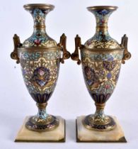 A PAIR OF 19TH CENTURY FRENCH CHAMPLEVE ENAMEL BRONZES VASES decorated with flowers. 15 cm high.