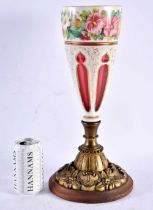 A LARGE 19TH CENTURY BOHEMIAN RUBY AND WHITE ENAMELLED VASE painted with flowers, upon a gilt
