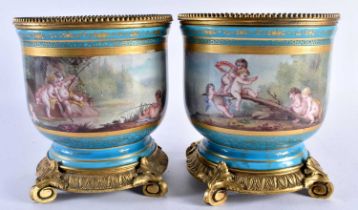 A LARGE PAIR OF 19TH CENTURY FRENCH SEVRES PORCELAIN BRONZE PLANTERS painted with figures within