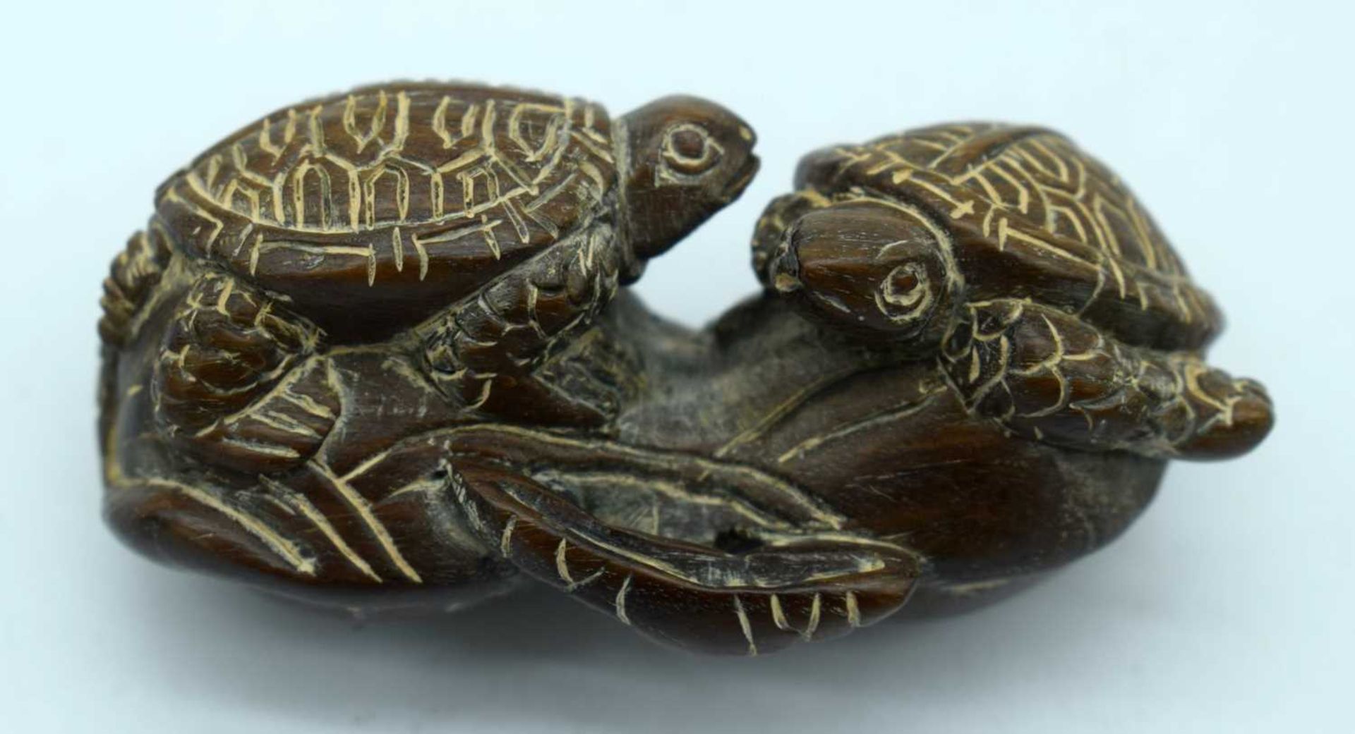 A Carved Hardwood Netsuke of Two Turtles. 2.8cm x 5.8cm x 2.7cm. Weight 27.1g