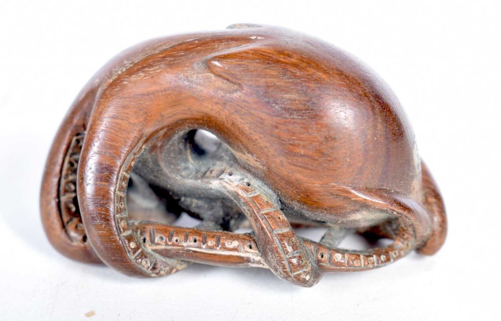 A Carved Wood Netsuke in the form of an Octopus Clinging to a Rock. 2.8cm x 5.1cm x 3.2cm, weight