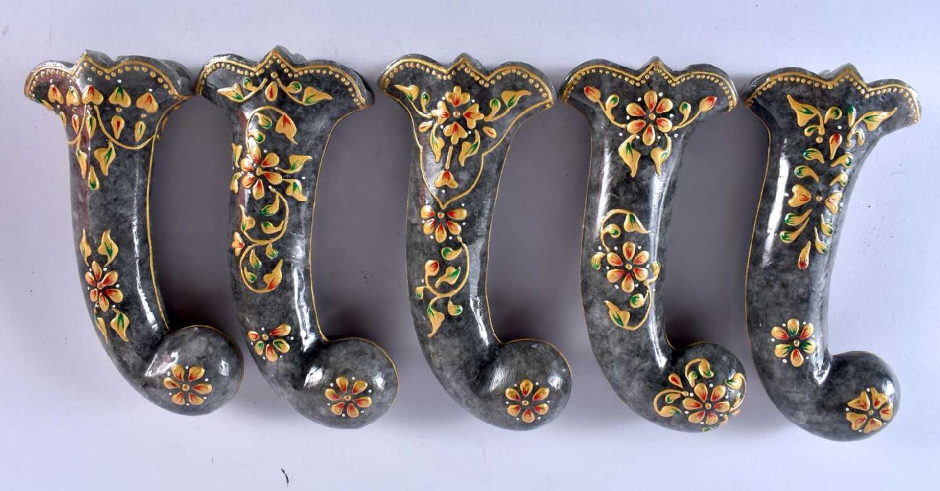 A SET OF FIVE MIDDLE EASTERN QAJAR LACQUER HARDSTONE DAGGER HANDLES overlaid with foliage and vines.