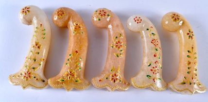 A SET OF FIVE MIDDLE EASTERN QAJAR LACQUER HARDSTONE DAGGER HANDLES overlaid with foliage and vines.