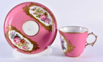 A LATE 19TH CENTURY FRENCH SEVRES PORCELAIN CUP AND SAUCER painted with floral panels of a pink