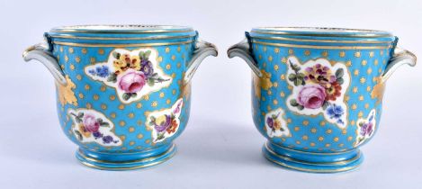 Sevres pair of bottle coolers painted with asymmetric gilt panel of flowers on a turquoise ground,