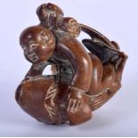A Carved Hardwood Netsuke of a Boy and a Fish. 4cm x 4.6cm x 2.5cm. Weight 17.9g