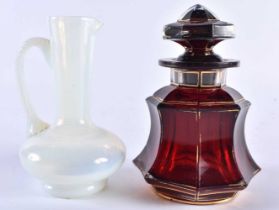 AN ANTIQUE BOHEMIAN GILDED RUBY GLASS SCENT BOTTLE AND STOPPER together with an opaline glass jug.