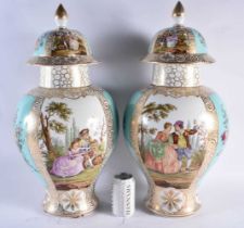 A VERY LARGE PAIR OF LATE 19TH CENTURY DRESDEN PORCELAIN VASES AND COVERS painted with lovers in a