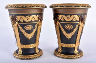 A VERY RARE PAIR OF 19TH CENTURY WEDGWOOD BLACK AND GILT JASPERWARE VASES decorated with mask