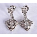 A FINE PAIR OF ART DECO PLATINUM AND DIAMOND EARRINGS with old European cut oval centres, each