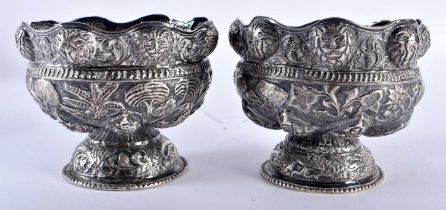 A PAIR OF 19TH CENTURY INDIAN SILVER REPOUSSE BOWLS decorated with figures. 286 grams. 10.5 cm x 8.