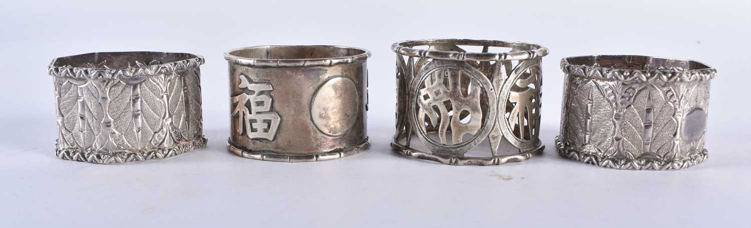 FOUR ASIAN SILVER NAPKIN RINGS and a pair of Chinese silver condiments. 174 grams. Largest 5 cm x - Image 2 of 7