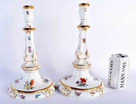 A LARGE PAIR OF 19TH CENTURY GERMAN KPM BERLIN PORCELAIN CANDLESTICKS painted with floral sprays. 29