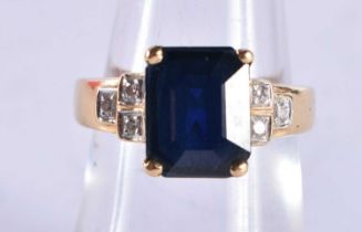 An 18 Ct Gold Ring set with a Blue Sapphire with diamond shoulder. Size M, weight 4.5g