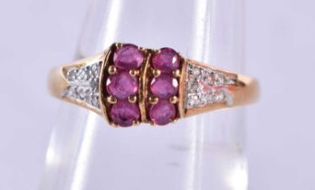 An 18 Ct Gold Ring set with 6 Rubies with diamond shoulder. Size M, weight 1.99g