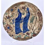 AN EARLY MIDDLE EASTERN FAIENCE IZNIK DISH. 23 cm diameter.