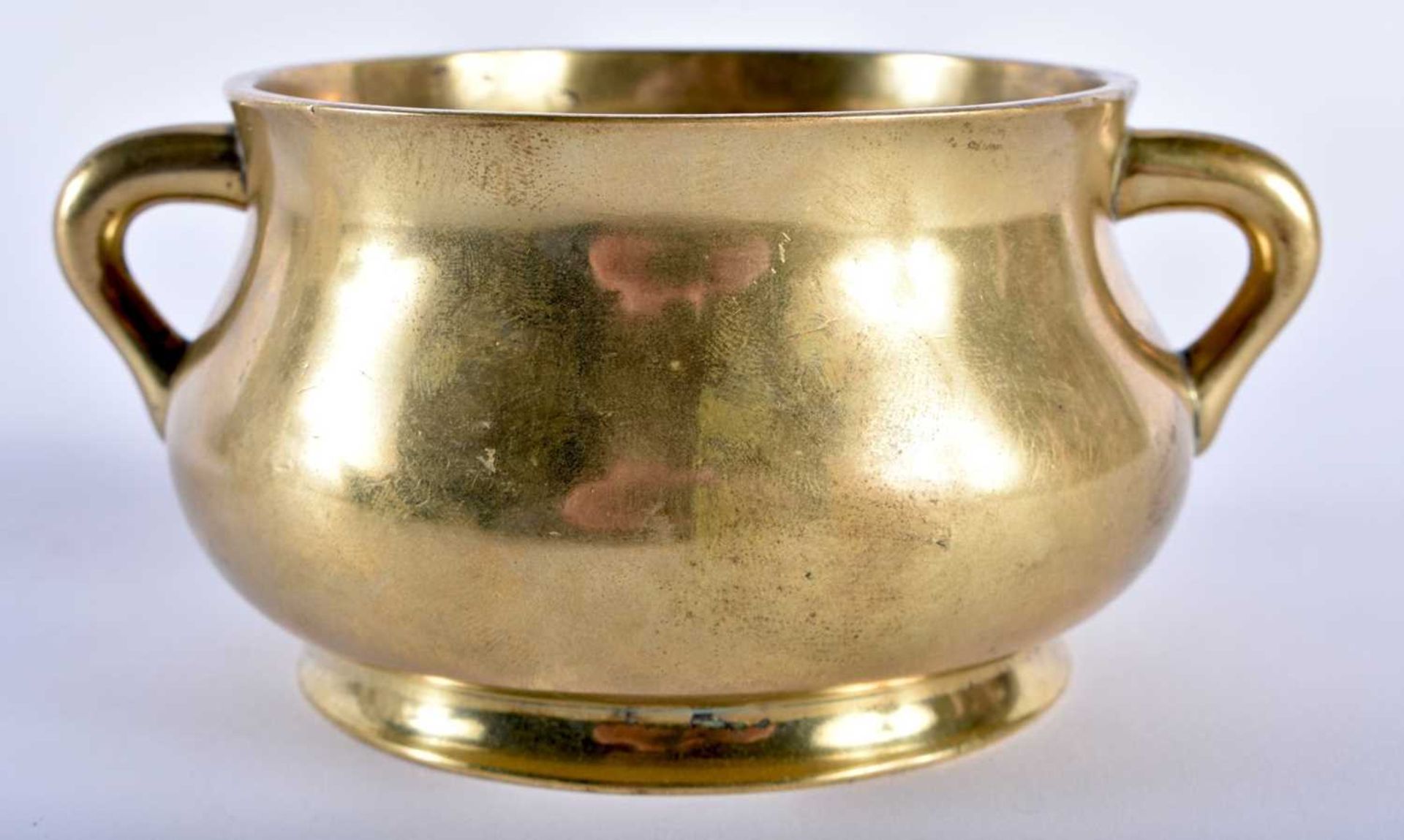 AN 18TH CENTURY CHINESE TWIN HANDLED BRONZE CENSER bearing Xuande marks to base, of plain form.