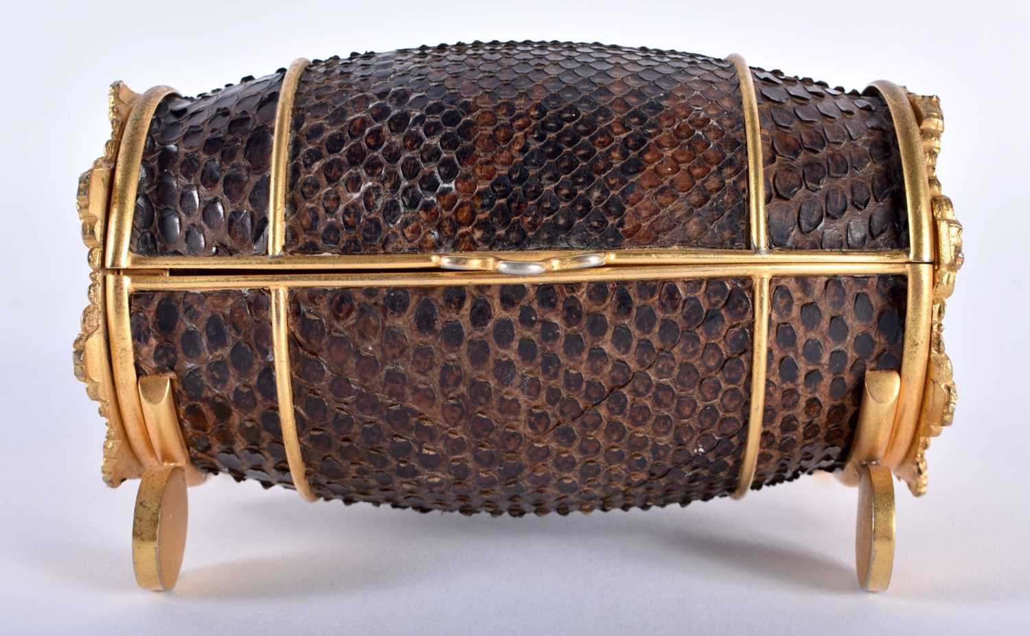 A RARE EARLY 20TH CENTURY FRENCH ORMOLU AND SNAKESKIN BOX of oval drum form, decorated to each end