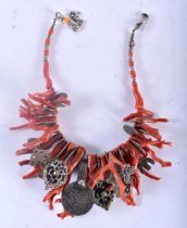 AN UNUSUAL 19TH CENTURY MIDDLE EASTERN ISLAMIC STICK CORAL NECKLACE set with a central Islamic coin.