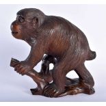 A 19TH CENTURY JAPANESE MEIJI PERIOD CARVED WOOD FIGURE OF A MONKEY modelled upon a stump. 18 cm x