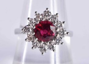A FINE 18CT WHITE GOLD RUBY AND DIAMOND RING the central stone 6.5 mm and approx 1.5 cts. 5.2 grams.