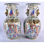 A LARGE PAIR OF 19TH CENTURY CHINESE CANTON FAMILLE ROSE PORCELAIN VASES Qing, painted with