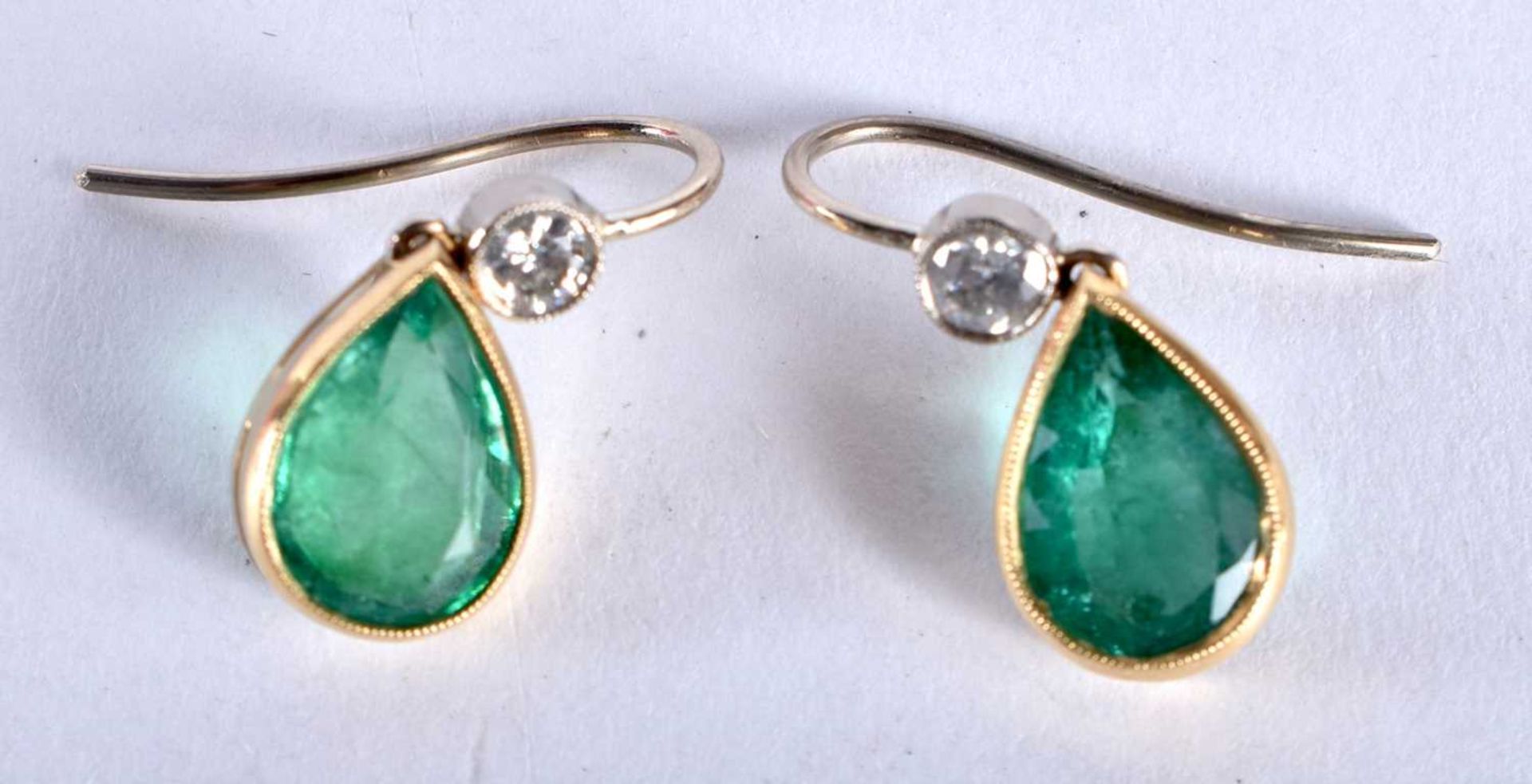 A PAIR OF 18CT GOLD DIAMOND AND EMERALD EARRINGS each emerald 10 mm x 8 mm and approx 1.25 cts each.