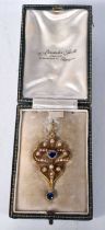 An Antique Gold (poss 15 Carat) Edwardian Pendant set with Pearls and Sapphires in a fitted case.