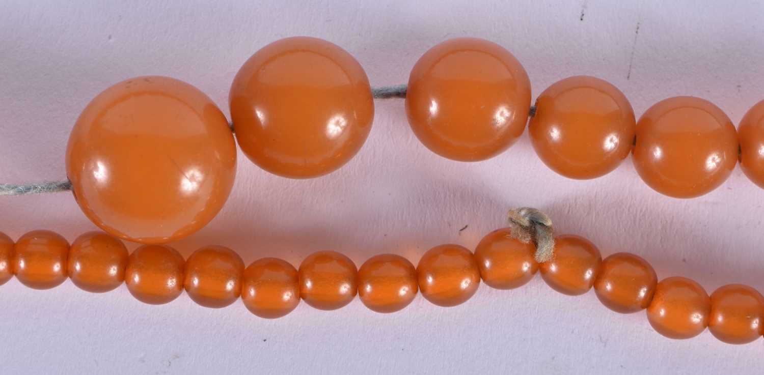 FOUR VINTAGE AMBER TYPE NECKLACES. 183 grams. Largest 88 cm long. (4) - Image 3 of 5