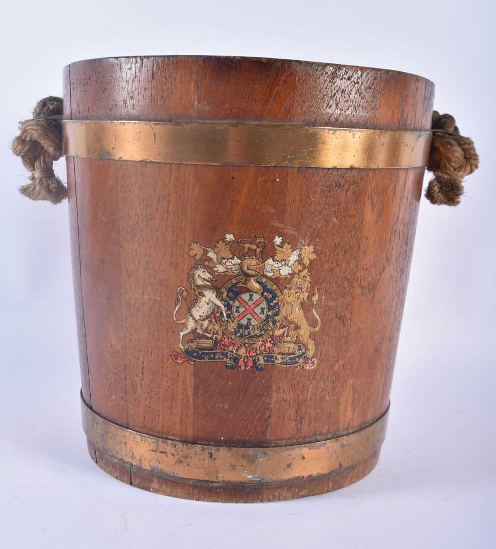 AN EDWARDIAN COUNTRY HOUSE OAK AND BRASS BOUND NAVAL FIRE BUCKET painted with a coat of arms. 34