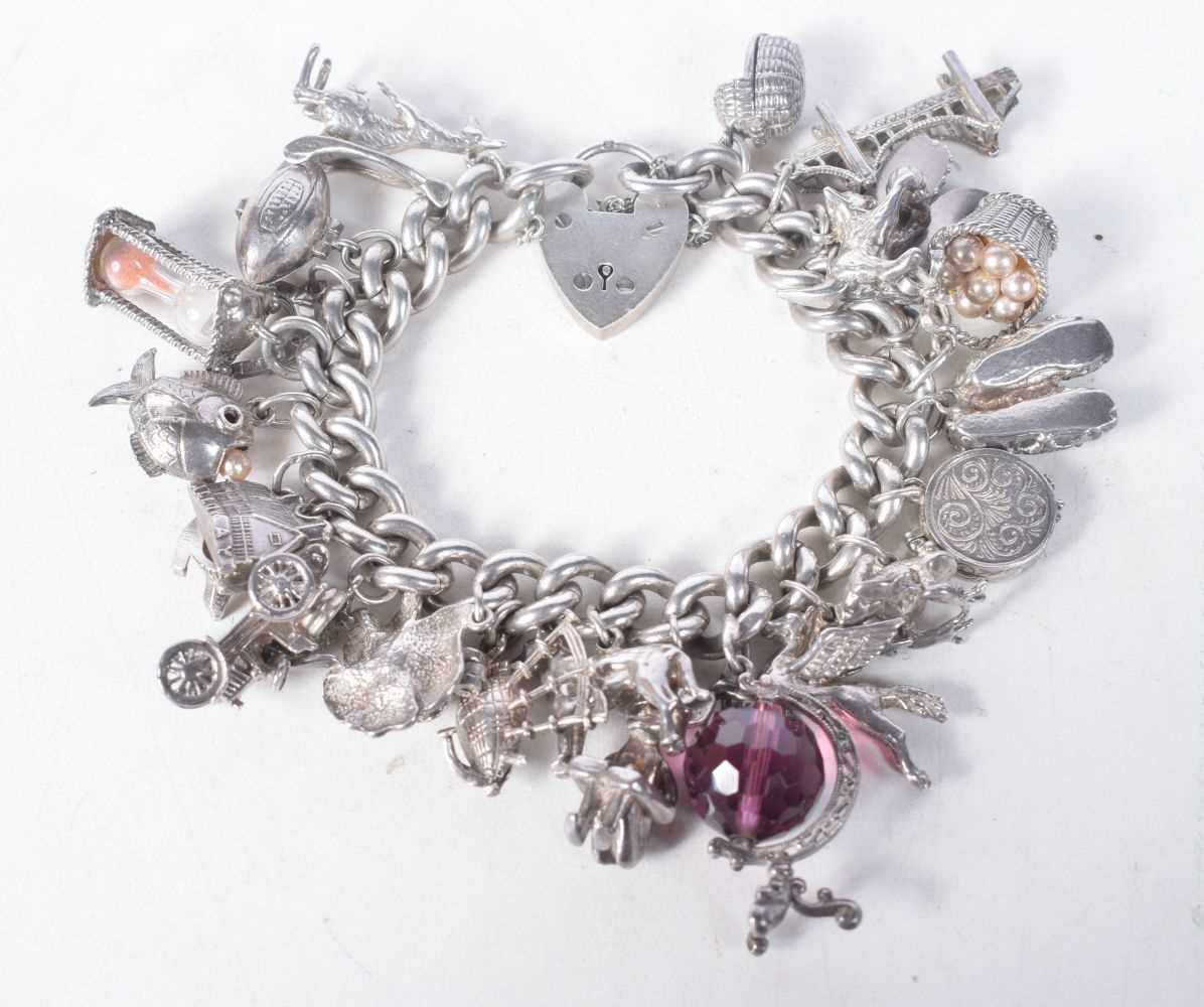 A Vintage Silver Charm Bracelet with 23 Charms. Bracelet Hallmarked Birmingham 1966. 4.2 cm internal