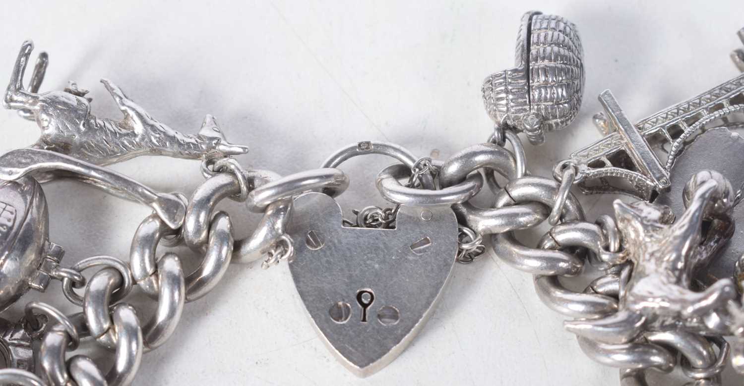 A Vintage Silver Charm Bracelet with 23 Charms. Bracelet Hallmarked Birmingham 1966. 4.2 cm internal - Image 2 of 5